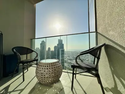 a room with two chairs and a table on a balcony at Your Home away from Home in Dubai