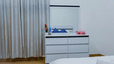 a white dresser with a mirror on top of it at Luxurious holiday homes in Dubai
