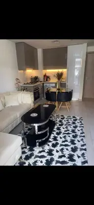 a living room with a couch and a table at Azizi riviera in Dubai