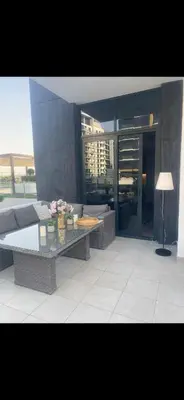 a living room with a couch and a table at Azizi riviera in Dubai