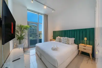 a bedroom with a large white bed and a green headboard at Stunning Views Spacious 3BR Dubai Marina in Dubai