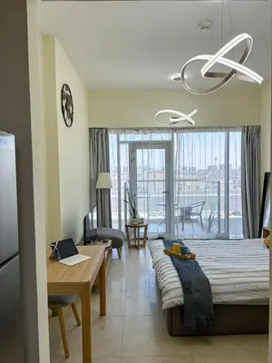 a living room with a couch and a dining room at Vibrant studio - 15m to marina in Dubai