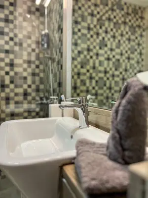 a bathroom with a sink and a shower at Vibrant studio - 15m to marina in Dubai