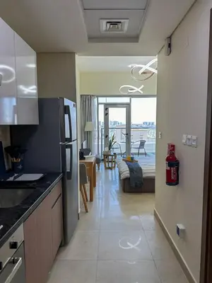 a kitchen and living room with a view of a living room at Vibrant studio - 15m to marina in Dubai
