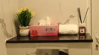 a table with a box and flowers on it at 1BHK Homes For Holidays in Dubai