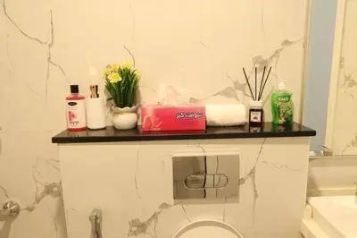 a bathroom with a counter with toiletries on it at 1BHK Homes For Holidays in Dubai