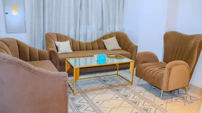 a living room with two couches and a coffee table at 1BHK Homes For Holidays in Dubai