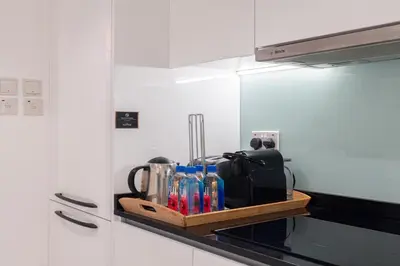 a kitchen counter with a tray with utensils on it at Boulevard Central Towers Downtown Dubai - By Home Of Choice in Dubai