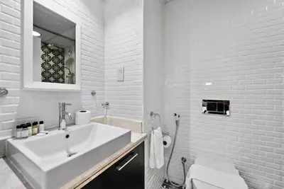 a white bathroom with a sink and a toilet at Boulevard Central Towers Downtown Dubai - By Home Of Choice in Dubai