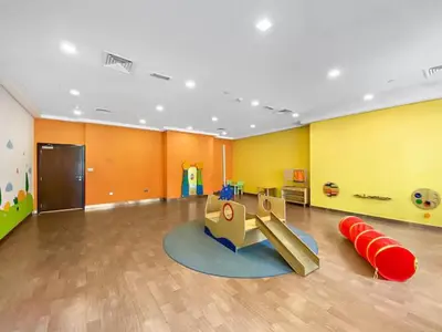 a childrens play room with a slide and a playground at Boulevard Central Towers Downtown Dubai - By Home Of Choice in Dubai