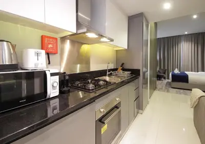 a kitchen with a stove and a microwave at Luxury Studio Apartment Canal View Near Dubai Mall in Dubai