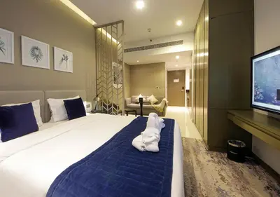 a hotel room with a large bed and a flat screen tv at Luxury Studio Apartment Canal View Near Dubai Mall in Dubai
