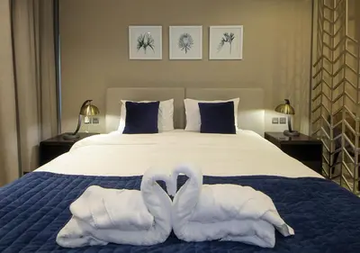two swans towels are sitting on a bed at Luxury Studio Apartment Canal View Near Dubai Mall in Dubai