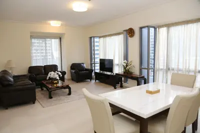 a living room with a white table and chairs at Luxury Two Bedroom Apt Facing Burj Khalifa in Dubai