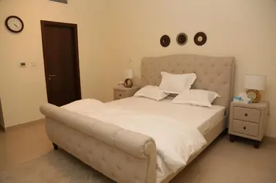 a bedroom with a large bed with white sheets and pillows at Luxury Two Bedroom Apt Facing Burj Khalifa in Dubai