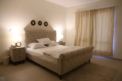 a bedroom with a large bed with a large headboard at Luxury Two Bedroom Apt Facing Burj Khalifa in Dubai