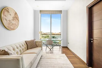 a living room with a couch and a table at Burj Alarab & Atlantis Palm Sea view, Beachfront, peaceful 3 Bedroom Apartment TIARA Residence with Pool, fast Wifi in Dubai