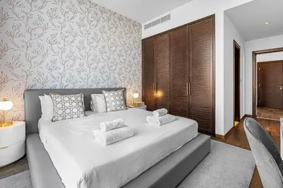 a bedroom with a large white bed with pillows at Burj Alarab & Atlantis Palm Sea view, Beachfront, peaceful 3 Bedroom Apartment TIARA Residence with Pool, fast Wifi in Dubai