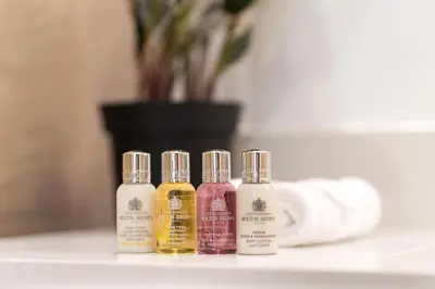 four bottles of essential oils sitting on a bathroom counter at Burj Alarab & Atlantis Palm Sea view, Beachfront, peaceful 3 Bedroom Apartment TIARA Residence with Pool, fast Wifi in Dubai