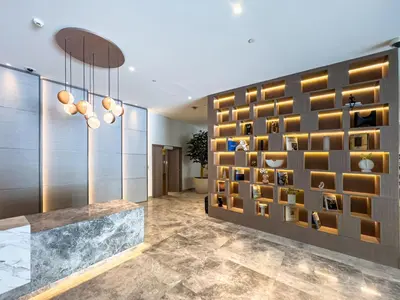 a lobby with a wall of wine bottles at Burj Royale 1 BR 5 Min Walk to Burj Khalifa in Dubai