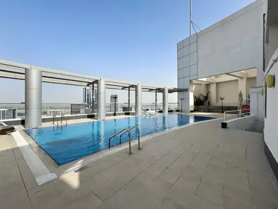 a large swimming pool on top of a building at Stylish Dubai Downtown Studio by Burj Khalifa in Dubai