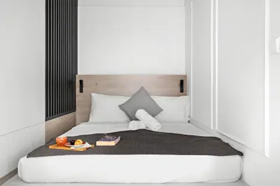 a white bed with a tray of food on it at Stylish Dubai Downtown Studio by Burj Khalifa in Dubai