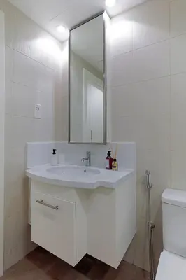 a white bathroom with a sink and a mirror at Luxury One-Bedroom Burj Khalifa in Dubai