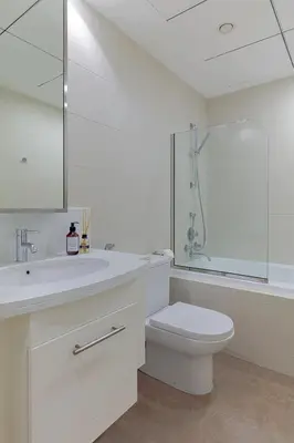 a bathroom with a toilet and a sink and a shower at Luxury One-Bedroom Burj Khalifa in Dubai