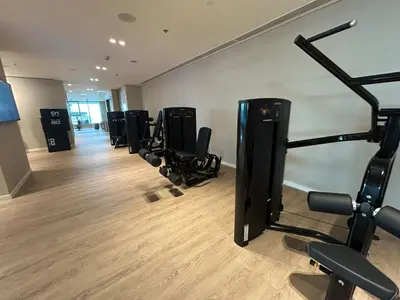 a gym with rows of cardio equipment in a room at Sea-facing 1BR at Beachfront 50 Off Eid Promo in Dubai