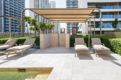 a patio with chairs and a pavilion in a city at Sea-facing 1BR at Beachfront 50 Off Eid Promo in Dubai
