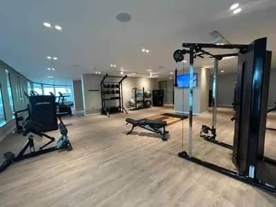 a gym with treadmills and machines in a room at Sea-facing 1BR at Beachfront 50 Off Eid Promo in Dubai