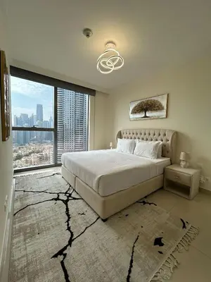 a bedroom with a large bed and a large window at 2BR Full Burj Khalifa View - Eid Promo 50 Off in Dubai