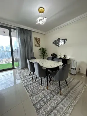a dining room with a table and chairs on a rug at 2BR Full Burj Khalifa View - Eid Promo 50 Off in Dubai