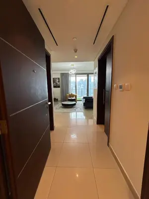 a hallway leading to a living room with a door at 2BR Full Burj Khalifa View - Eid Promo 50 Off in Dubai