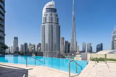 a swimming pool with a view of a city skyline at 2BR Full Burj Khalifa View - Eid Promo 50 Off in Dubai