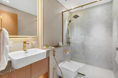 a bathroom with a toilet and a sink and a shower at Your Own Pool Spacious 2BDR Apartment JVC in Dubai