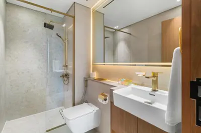 a bathroom with a toilet and a sink and a shower at Your Own Pool Spacious 2BDR Apartment JVC in Dubai