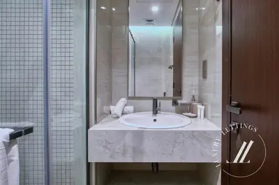 a bathroom with a sink and a mirror at 3BDR Business Bay Bliss High Floor Private Balcony in Dubai