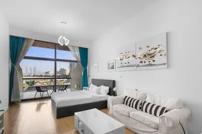 a living room with a couch and a table at Bright Beachfront Studio with Breathtaking Views in Dubai
