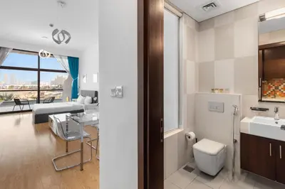 a bathroom with a sink and a toilet at Bright Beachfront Studio with Breathtaking Views in Dubai