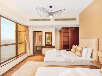 a bedroom with two beds and a large window at New! JBR Beachfront with Panoramic Dubai Eye Views in Dubai