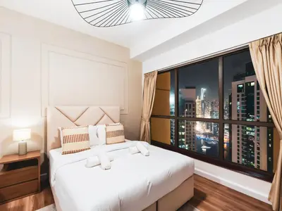 a bedroom with a white bed and a large window at New! JBR Beachfront with Panoramic Dubai Eye Views in Dubai