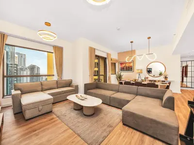 a living room with a couch and a table at New! JBR Beachfront with Panoramic Dubai Eye Views in Dubai