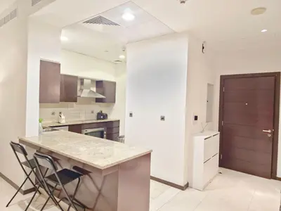 a kitchen with a counter and a island in a room at The Palm Panorama Chic Apartment with Open Sea Views Managed by SunnyHomes in Dubai