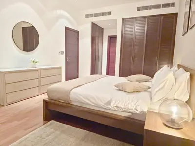 a bedroom with a large bed and a mirror at The Palm Panorama Chic Apartment with Open Sea Views Managed by SunnyHomes in Dubai