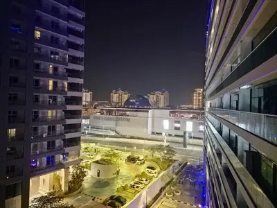a view of a city at night from a building at The Palm Hideaway Chic Apartment with Rooftop Vibes Managed by SunnyHomes in Dubai