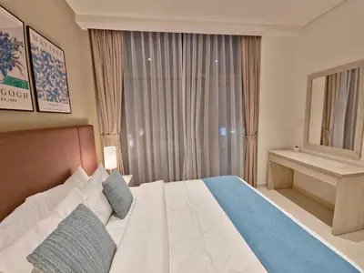 a bedroom with a large bed and a window at The Palm Hideaway Chic Apartment with Rooftop Vibes Managed by SunnyHomes in Dubai