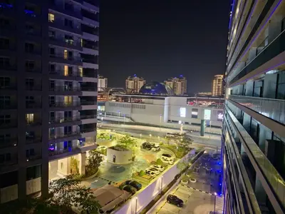 a view of a city at night with buildings at The Palm Hideaway Chic Apartment with Rooftop Vibes Managed by SunnyHomes in Dubai