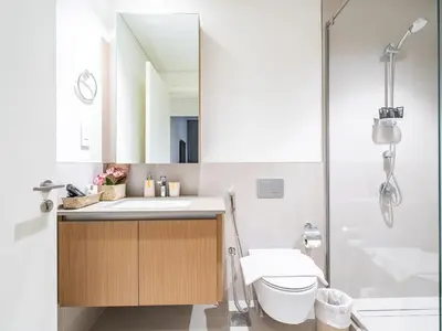 a bathroom with a sink and a toilet and a shower at Enjoy Sunset at Creek Beach in Dubai