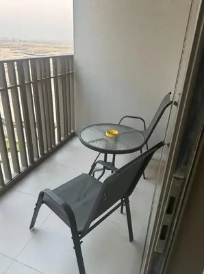 a balcony with a table and chairs on a balcony at Enjoy Sunset at Creek Beach in Dubai
